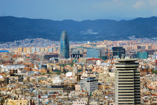panorama of Barcelona with a kind on a tower and the Pyrenees mo