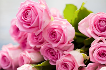 bouquet of pink roses lies on a pool side