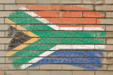 flag of South Africa on grunge brick wall painted with chalk