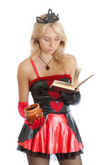 teenager princess girl in gloves and crown reads a book