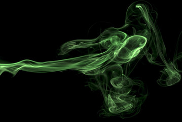 Abstract green colored smoke, black background.