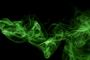 Abstract green colored smoke, black background.