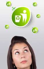 Young girl looking at green eco sign