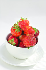 strawberries in a bowl in the daylight