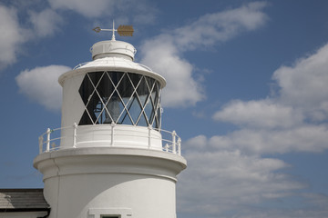 Lighthouse against Blue Sky Background