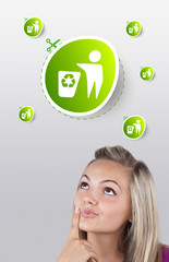 Young girl looking at green eco sign