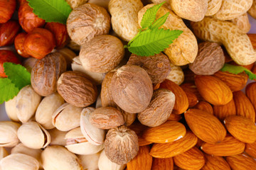 almonds, nutmeg, peanuts and pistachios isolated on white