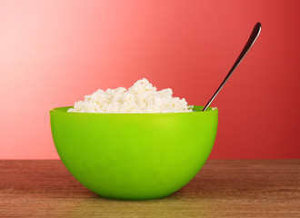 Cottage cheese  in bowl on blue background