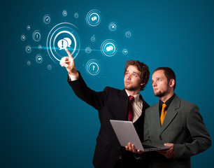 Businessman pressing modern social type of icons