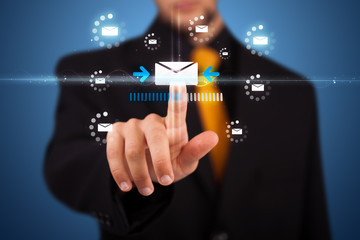 Businessman pressing virtual messaging type of icons