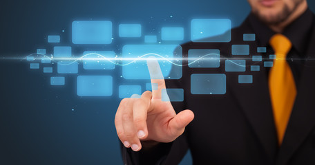 Businessman pressing high tech type of modern buttons