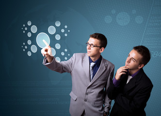 Businessman pressing high tech type of modern buttons