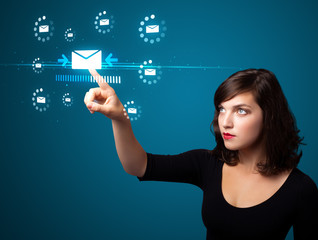 Businesswoman pressing virtual messaging type of icons