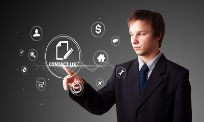Businessman pressing virtual messaging type of icons