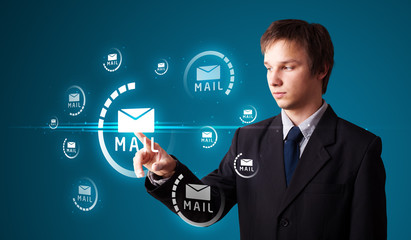 Businessman pressing virtual messaging type of icons