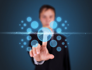 Businessman pressing high tech type of modern buttons