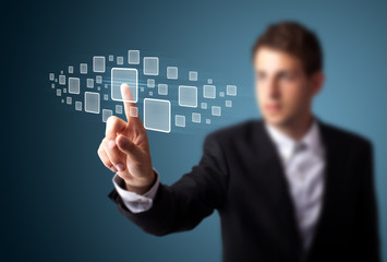 Businessman pressing high tech type of modern buttons