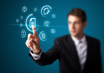 Businessman pressing virtual messaging type of icons