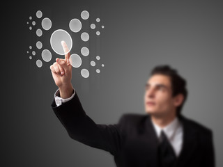 Businessman pressing high tech type of modern buttons