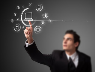 Businessman pressing virtual media type of buttons