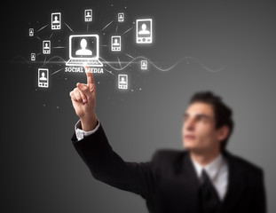 Businessman pressing modern social type of icons