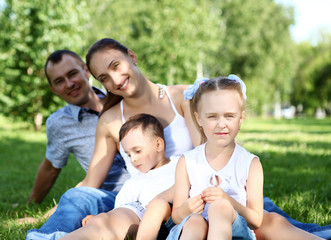 Family with two children in the summer park