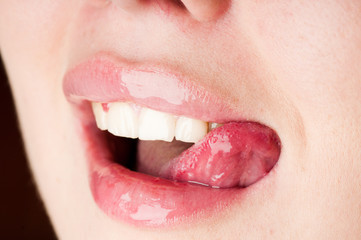 Naklejka premium young female licking her pink lips