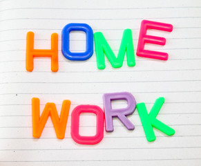 Homework in colorful toy letters on lined paper background