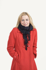 Freezing young woman in red coat