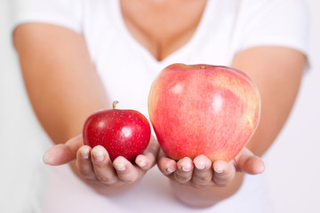 Fresh red apples in a woman hand close up