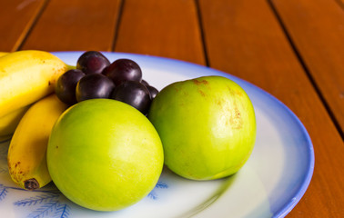 Tropical fruits on wood table