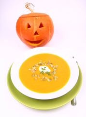 Pumpkin soup with Jack-o'-lantern in the background