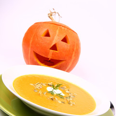 Pumpkin soup with Jack-o'-lantern in the background