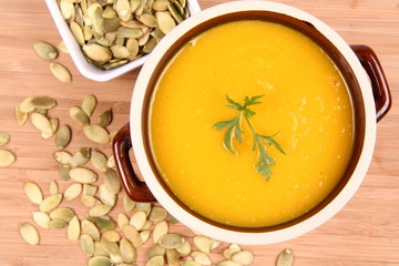 Pumpkin soup and a bowl of pumpkin seeds