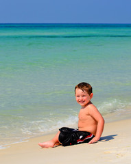 Portrait of young boy playing in surf at beach