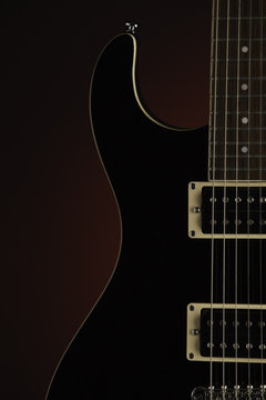 Black Electric Guitar on Red