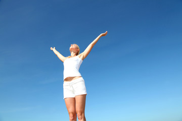 Fototapeta na wymiar Woman stretching arms up from freedom