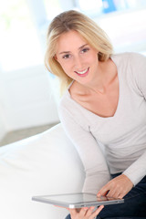 Beautiful woman using tablet at home
