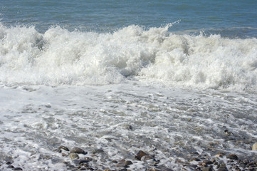 Fototapeta premium Foam of water and waves of surf on the sea coastline