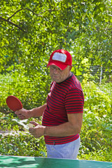 man play tennis outdoor in summer