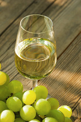 wine and grapes on wooden table