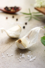 Fototapeta na wymiar Garlic cloves with peppercorn, salt, rosemary and mint