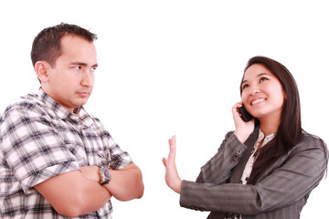 smiling businesswoman on the phone signaling his couple to hold