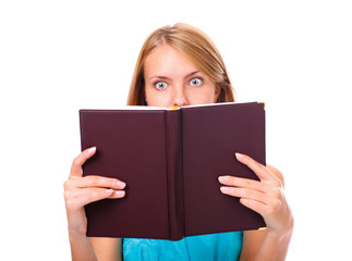 Portrait of young woman amazed by what she is reading