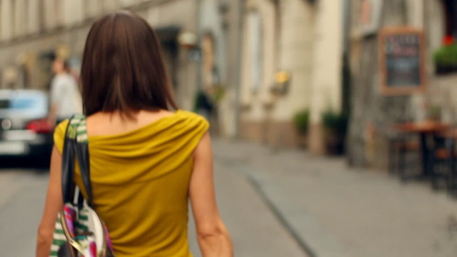 woman with shopping bags walking in the city, slow motion