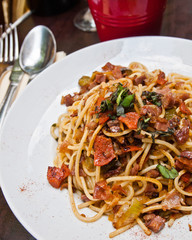 tasty pasta with roast ham on the table