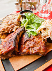 Grilled steak - Grilled meat ribs on the plate with hot sauce