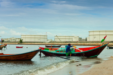 Fototapeta na wymiar fishing boat with power plant background