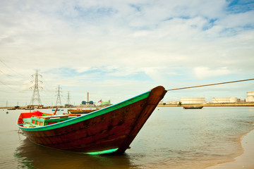 Obraz premium fishing boat with power plant background