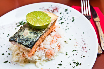 grilled salmon and lemon - french cuisine dish with tomato and s